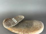a stone with a tag on it sitting on a table
