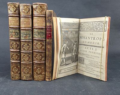 several old books are stacked on top of each other on a table
