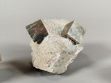 a small rock with a piece of silver on top of it
