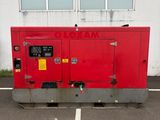 a red generator in a parking lot next to a building