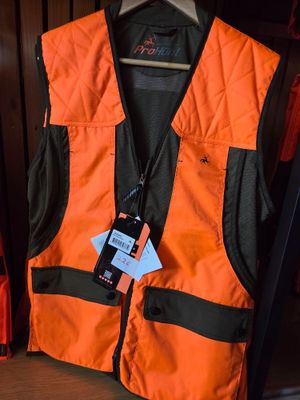 an orange vest with a tag on it sitting on a shelf