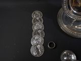 a silver plate with a spoon and spoon rest on a table