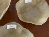 three bowls sitting on a table with labels on them