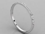 a white gold wedding ring with diamonds on a gray background