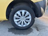 a yellow car that is parked on the side of the road