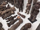 a lot of wooden statues that are on a table
