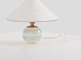 a lamp that has a white shade on it