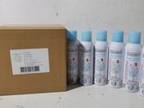 several bottles of lotion sitting next to a cardboard box on a table
