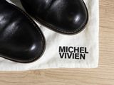 michael vivien shoes on a white cloth on a wooden table