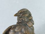 a statue of a bird that is sitting on top of a table
