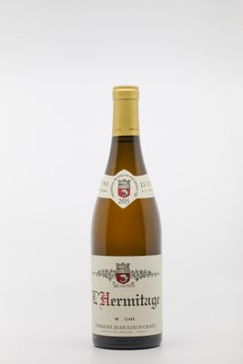 la bouteille de vin est posée sur une surface blanche