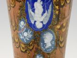 a brown vase with a blue and white design on it