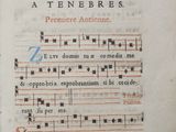 an old book with a page of music written on it
