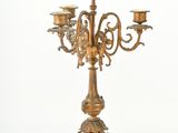 a gold colored candelab with three candles on it