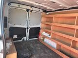 a white van that has some shelves in the back