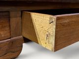 a wooden desk with a drawer on top of it