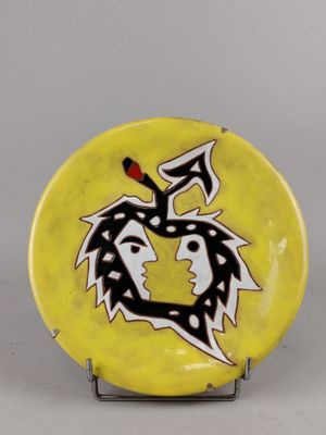une assiette jaune ornée d'un motif en noir et blanc