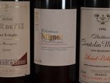 three bottles of wine are lined up on a table