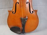 a violin that is sitting on a white surface