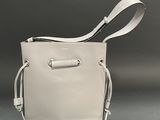 an image of a white purse with a white strap