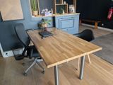 a wooden table with a laptop on it in a room