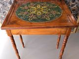 a wooden table with a green and yellow floral design on it