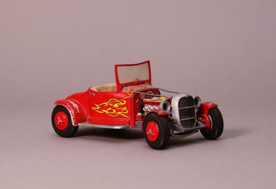 a red toy car with flames on the side of it