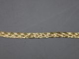 a close up of a gold braided bracelet on a gray surface