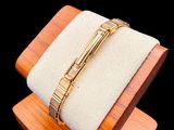 bracelet on a wooden stand on a black background with a black and white photo