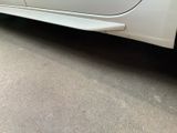a white car parked on the side of the road