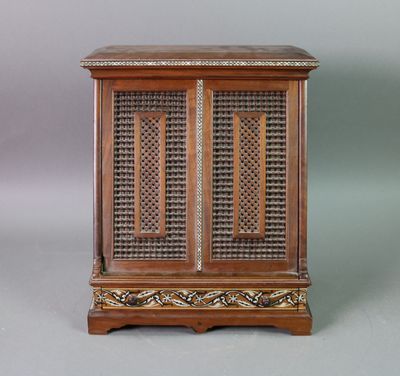 an image of a wooden cabinet with intricate carvings on the doors