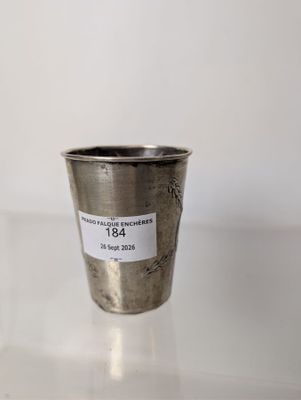 a silver cup with a sticker on it sitting on a table