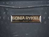 a close up of a black purse with a name plate on it