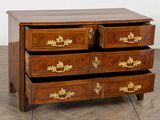 a wooden chest of drawers with gold decorations on it