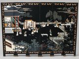 une image représentant un paravent noir et doré orné de scènes orientales