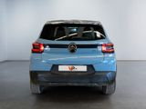 the rear end of a blue mercedes suv parked in a showroom