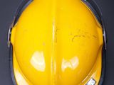 a yellow hard hat that is on a table