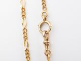 a close up of a gold chain with a lock on it