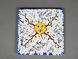 a painting of a sun that is on the wall
