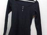 black long sleeved shirt with buttons on the front and back