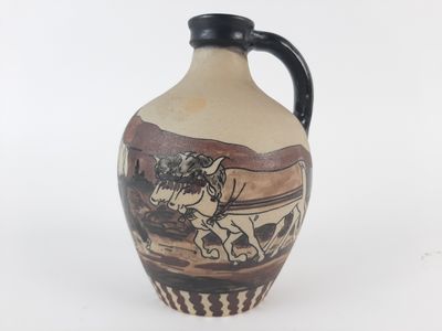 a vase with a horse drawn on it on a white surface