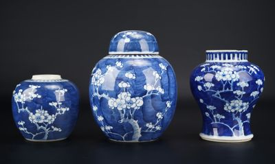 three blue and white vases sitting next to each other