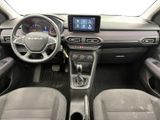 the interior of a car with a steering wheel, dashboard, and dashboard controls