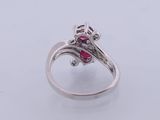 a close up of a ring with a ruby stone in it