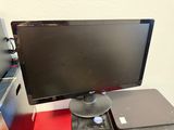 a computer monitor sitting on top of a red desk