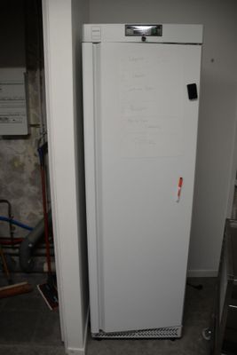 a white refrigerator in the corner of a room