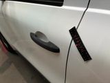 a sticker on the door handle of a white car