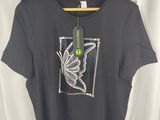a t shirt with a butterfly on it hanging on a hanger