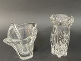 two glass vases that are sitting on a table