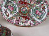 a plate with a bird on it sitting on a table next to a vase